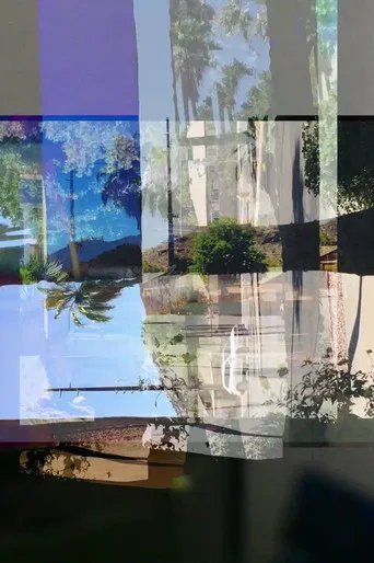 Hiding Under a Copy of the Strokes' Single 'Under Cover of Darkness' poster