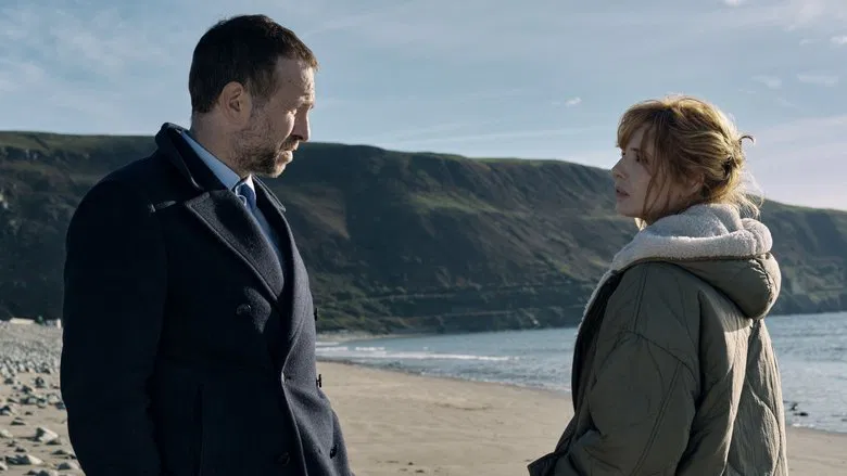 Kelly Reilly as Jackie Ellis standing on a wind-swept marsh