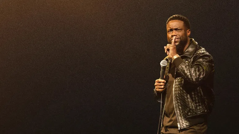 Kevin Hart sitting on a stool on stage