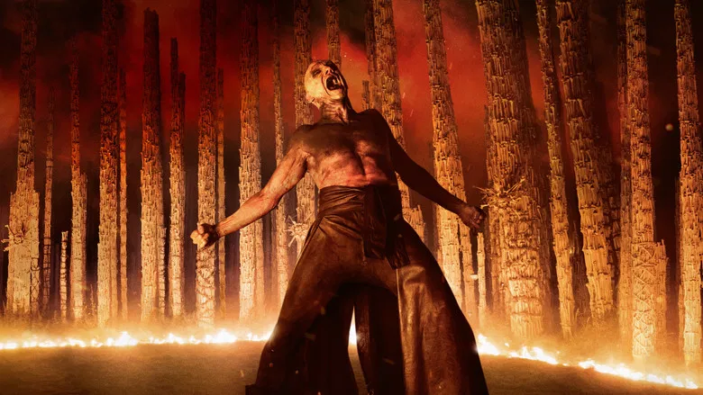 Jack O'Connell as Jimmy Crystal addressing his cult in the ruins